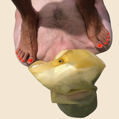 Close-up of feet beside a yellow fabric hood
