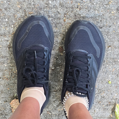 Black gym trainers being worn outdoors