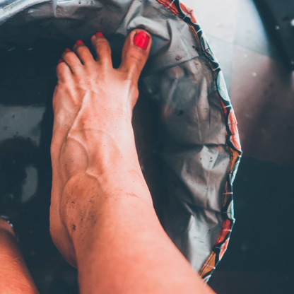 Red-painted toenails beside a foot spa basin